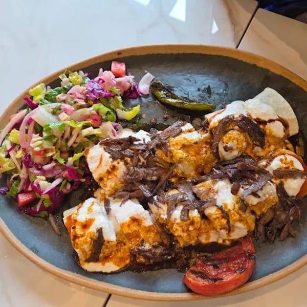 Marash Mediterranean's Iskender kebab with yogurt, tomato sauce, grilled pepper, and a side salad.